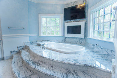 Example of a large classic master white tile and stone slab marble floor doorless shower design in DC Metro with white cabinets, a hot tub, a one-piece toilet, blue walls, a drop-in sink and marble countertops