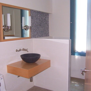 Small trendy kids' blue tile and porcelain tile porcelain tile walk-in shower photo in Tampa with a vessel sink, flat-panel cabinets, light wood cabinets, wood countertops and white walls