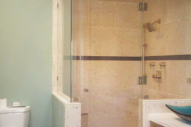 Mid-sized transitional master beige tile and stone tile slate floor and gray floor alcove shower photo in Orange County with raised-panel cabinets, medium tone wood cabinets, green walls, a vessel sink, quartz countertops and a hinged shower door