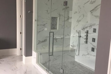 Example of a large trendy master white tile and marble tile marble floor and white floor alcove shower design in Toronto with gray walls and a hinged shower door