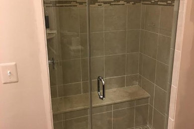 Inspiration for a transitional gray tile and matchstick tile alcove shower remodel in DC Metro with beige walls and a hinged shower door