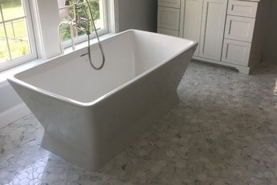 Design ideas for a medium sized classic ensuite bathroom in Other with shaker cabinets, white cabinets, a freestanding bath, grey walls, marble flooring, marble worktops, white floors, a two-piece toilet, grey tiles, marble tiles and a built-in sink.
