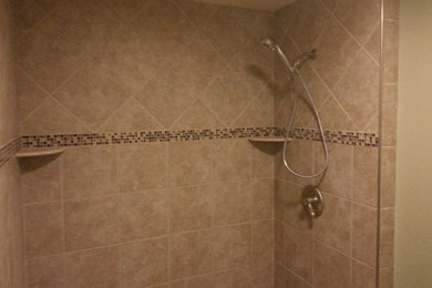Doorless shower - contemporary beige tile and porcelain tile doorless shower idea in Indianapolis with a two-piece toilet