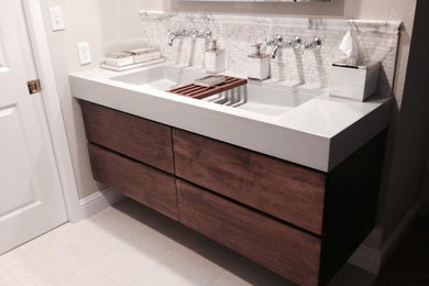 Bathroom - mid-sized modern white tile and marble tile ceramic tile and white floor bathroom idea in San Francisco with flat-panel cabinets, dark wood cabinets, gray walls, a trough sink, quartz countertops and white countertops