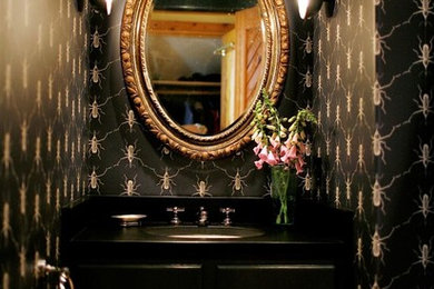 Small eclectic single-sink and wallpaper bathroom photo in Other with black walls, raised-panel cabinets, black cabinets, an undermount sink, quartz countertops, black countertops and a built-in vanity