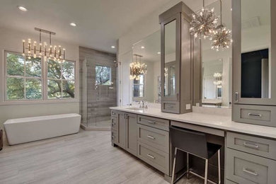 Example of a large transitional master gray tile and porcelain tile porcelain tile and gray floor bathroom design in Austin with shaker cabinets, gray cabinets, white walls, an undermount sink, quartzite countertops, a hinged shower door and white countertops