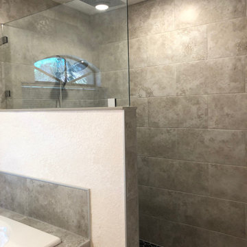 Custom zero entry, ceiling mounted shower head and linear drain bathroom
