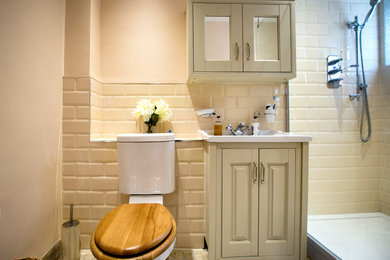 Inspiration for a small traditional bathroom in Essex with raised-panel cabinets, a walk-in shower, a one-piece toilet, yellow walls, ceramic flooring, multi-coloured floors and an open shower.