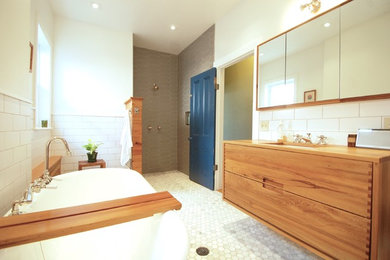 This is an example of a medium sized contemporary ensuite bathroom in Philadelphia with a claw-foot bath, a walk-in shower, white tiles, porcelain tiles, white walls, marble flooring, a submerged sink, white floors, an open shower, flat-panel cabinets, light wood cabinets, wooden worktops and brown worktops.
