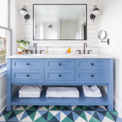 Example of an eclectic cement tile floor and multicolored floor bathroom design in DC Metro with recessed-panel cabinets, blue cabinets, white walls and an undermount sink