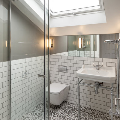 Small ornate master white tile and ceramic tile ceramic tile and multicolored floor corner shower photo in London with glass-front cabinets, a wall-mount toilet, gray walls, a pedestal sink and a hinged shower door