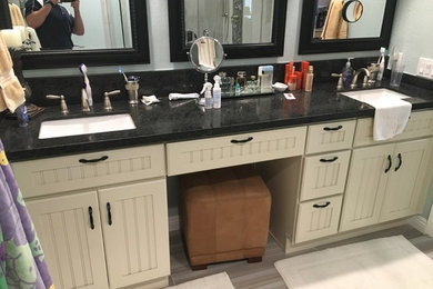 Bathroom - mid-sized contemporary master pebble tile porcelain tile bathroom idea in Orange County with shaker cabinets, white cabinets, a bidet, green walls, an undermount sink and quartzite countertops