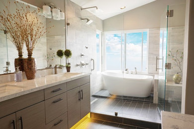 Mid-sized minimalist master porcelain tile porcelain tile and black floor bathroom photo in Orange County with flat-panel cabinets, beige cabinets, a one-piece toilet, a drop-in sink, quartz countertops, a hinged shower door and beige walls