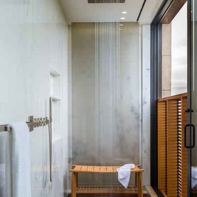 Trendy beige tile shower bench photo in New York with a niche