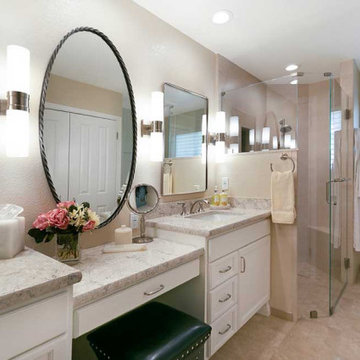 Primary Bathroom Vanity with Four Sconces and Metal Framed Mirrors
