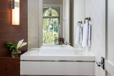 Bathroom - small coastal 3/4 travertine floor, beige floor, single-sink and wallpaper bathroom idea in Miami with flat-panel cabinets, white cabinets, a one-piece toilet, white walls, a vessel sink, wood countertops, white countertops and a floating vanity