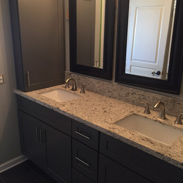 Dark grey shaker bathroom vanity with quartz countertops
