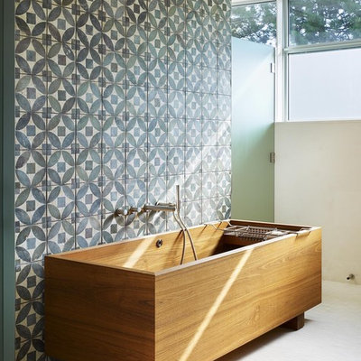 Mid-sized trendy master blue tile and stone tile mosaic tile floor freestanding bathtub photo in Toronto with blue walls