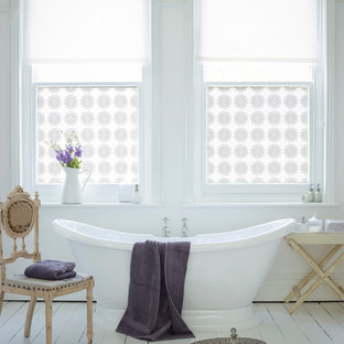 Design ideas for a shabby-chic style bathroom in Buckinghamshire with a freestanding tub and painted wood floors.