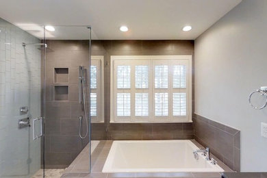 Mid-sized minimalist master gray tile and porcelain tile porcelain tile and white floor bathroom photo in Raleigh with furniture-like cabinets, white cabinets, a two-piece toilet, gray walls, an undermount sink, quartz countertops, a hinged shower door and gray countertops