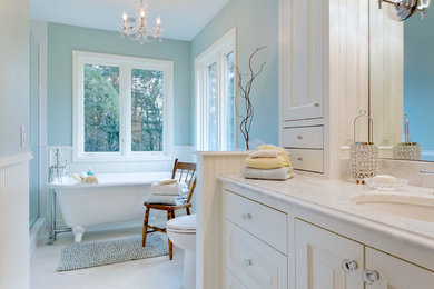 Inspiration for a timeless white tile and subway tile bathroom remodel in Portland with an undermount sink, raised-panel cabinets, white cabinets, marble countertops and a two-piece toilet
