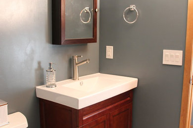 Alcove shower - small craftsman 3/4 gray tile and porcelain tile porcelain tile alcove shower idea in Other with an integrated sink, furniture-like cabinets, dark wood cabinets, a two-piece toilet and blue walls