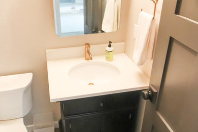 Example of a 3/4 bathroom design in Other with black cabinets, an undermount sink, quartz countertops and white countertops