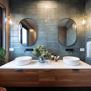 Design ideas for a mid-sized contemporary master bathroom in Canberra - Queanbeyan with flat-panel cabinets, medium wood cabinets, gray tile, beige walls, a vessel sink and white benchtops.