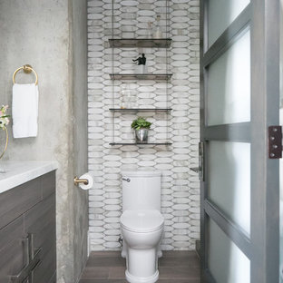 Inspiration for a small modern 3/4 white tile and stone tile porcelain tile and gray floor alcove shower remodel in San Diego with flat-panel cabinets, dark wood cabinets, a one-piece toilet, gray walls, an undermount sink, marble countertops and a hinged shower door