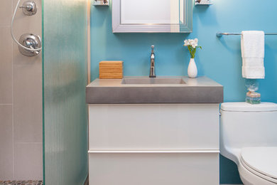 Small contemporary bathroom in Chicago with an integrated sink, a walk-in shower, a two-piece toilet, flat-panel cabinets, concrete worktops, beige tiles, porcelain tiles, blue walls, porcelain flooring and white cabinets.