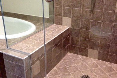 Example of a mid-sized transitional beige tile, black tile, brown tile, gray tile and ceramic tile ceramic tile bathroom design in Other with beige walls and a hinged shower door