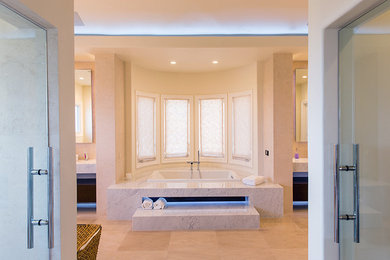 Example of a huge trendy master limestone floor bathroom design in Los Angeles with a vessel sink, flat-panel cabinets, dark wood cabinets, marble countertops and a one-piece toilet