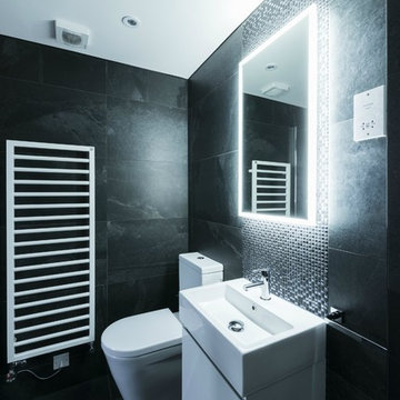 Designer Luxury Black Themed Bathroom with Mosaic Backsplash, Illuminating Mirro