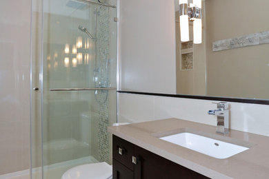 Example of a trendy beige tile alcove shower design in Ottawa with an undermount sink, shaker cabinets, dark wood cabinets, quartz countertops and beige walls