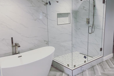 Inspiration for a large modern master white tile and porcelain tile porcelain tile and gray floor freestanding bathtub remodel in Los Angeles with shaker cabinets, white cabinets, a two-piece toilet, white walls, an undermount sink, quartzite countertops, a hinged shower door and gray countertops