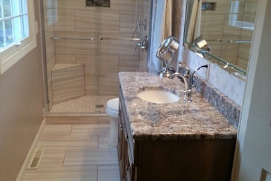 Example of a mid-sized transitional 3/4 beige tile and porcelain tile porcelain tile alcove shower design in Other with dark wood cabinets, gray walls, an undermount sink and granite countertops