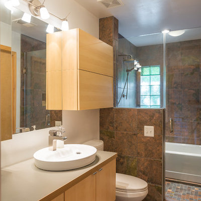 Example of a trendy brown tile bathroom design in DC Metro with a vessel sink, flat-panel cabinets, light wood cabinets and a one-piece toilet