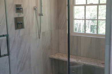 Example of a mid-sized trendy master gray tile and porcelain tile porcelain tile corner shower design in Boston with shaker cabinets, white cabinets, a one-piece toilet, green walls, an undermount sink and quartz countertops