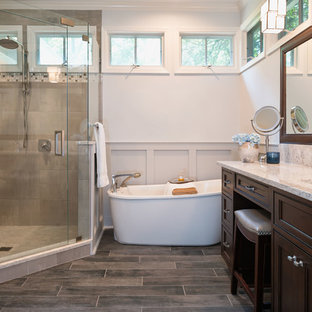 Example of a mid-sized arts and crafts master gray tile and porcelain tile porcelain tile bathroom design in Charlotte with beaded inset cabinets, dark wood cabinets, a two-piece toilet, blue walls, an undermount sink and quartz countertops