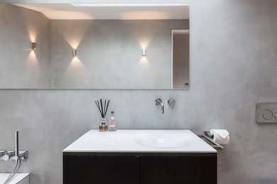 This is an example of a medium sized modern shower room bathroom in London with open cabinets, grey cabinets, a walk-in shower, a one-piece toilet, grey walls, concrete flooring, a built-in sink, concrete worktops, grey floors and an open shower.