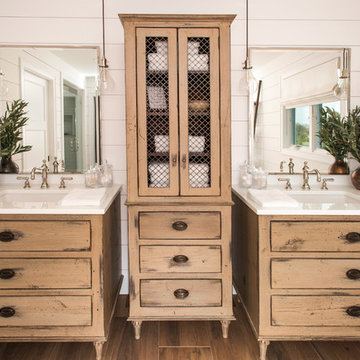 Distressed vanity bases and tall linen, glass vanity tops.