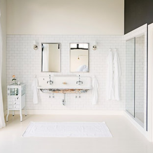 Industrial bathroom in Portland with a trough sink, white tile, subway tile and multi-coloured walls.