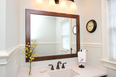 Mid-sized elegant 3/4 bathroom photo in Other with raised-panel cabinets, dark wood cabinets, white walls, an undermount sink and quartz countertops
