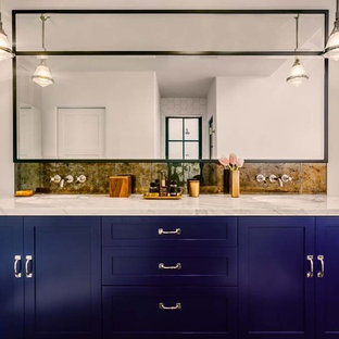 This is an example of a large eclectic master bathroom in Los Angeles with a drop-in sink, shaker cabinets, blue cabinets, marble benchtops, mirror tile, white walls and dark hardwood floors.