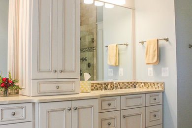 Bathroom - large traditional master multicolored tile and ceramic tile ceramic tile bathroom idea in DC Metro with raised-panel cabinets, white cabinets, a one-piece toilet, blue walls, an undermount sink and granite countertops