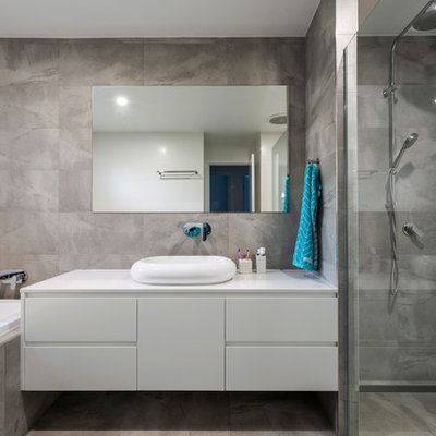 Example of a trendy master gray tile gray floor bathroom design in Gold Coast - Tweed with flat-panel cabinets, white cabinets, gray walls and a vessel sink