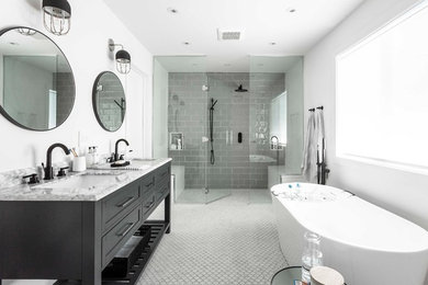 Inspiration for a large contemporary master gray tile and subway tile mosaic tile floor and white floor bathroom remodel in Montreal with furniture-like cabinets, gray cabinets, white walls, an undermount sink, marble countertops, a hinged shower door, a bidet and white countertops