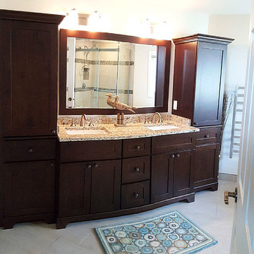 Double vanity and linen towers in a chestnut finish