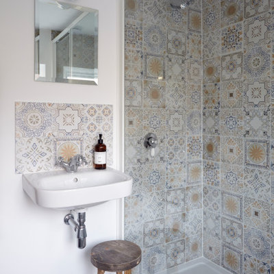 Bathroom - scandinavian 3/4 multicolored tile and mosaic tile gray floor and single-sink bathroom idea with white walls and a wall-mount sink