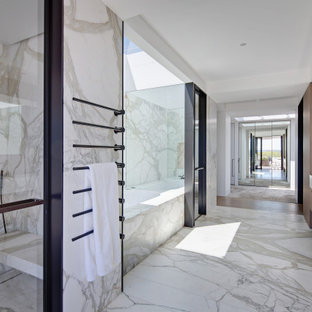 Design ideas for a modern bathroom in Sydney with flat-panel cabinets, dark wood cabinets, an undermount tub, white tile, stone slab, white walls, an integrated sink, white floor and white benchtops.